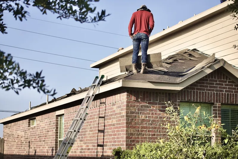 Professional roofer working on a residential roof in Humphreyville